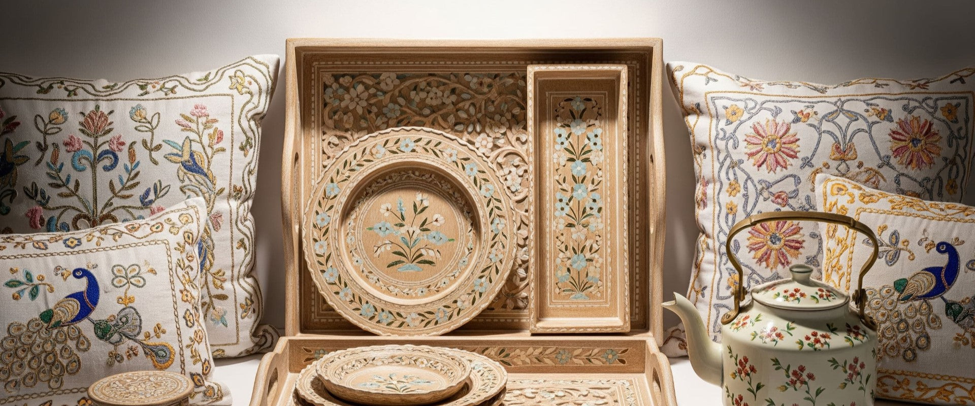 Decorative ceramic set with intricate designs on a floral-patterned background