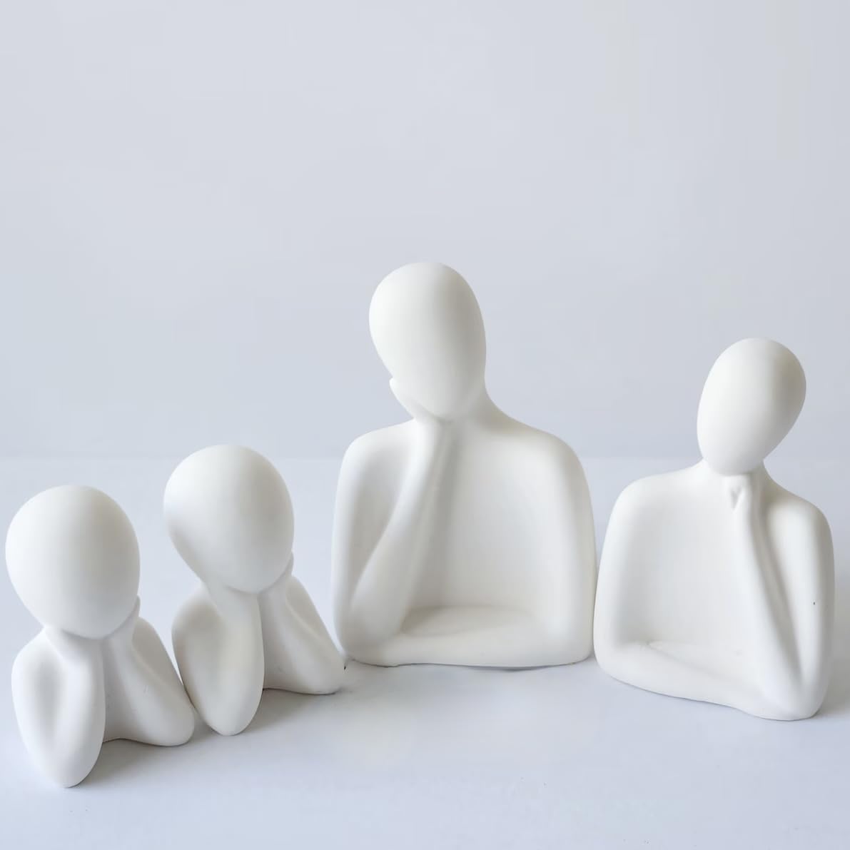 Set of white ceramic figures on a light gray background