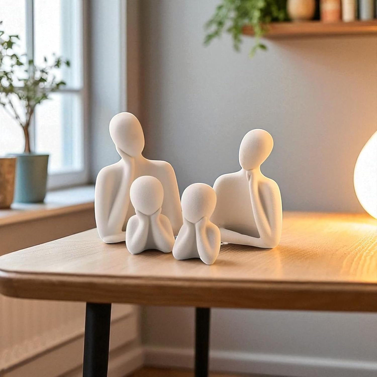 White abstract human figures on a wooden table with a blurred indoor background