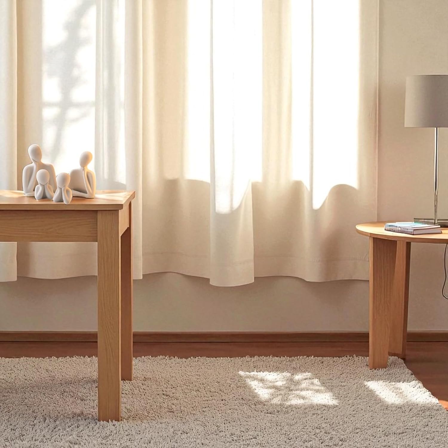 Two wooden tables with decorative items in a room with light-colored curtains and carpet.