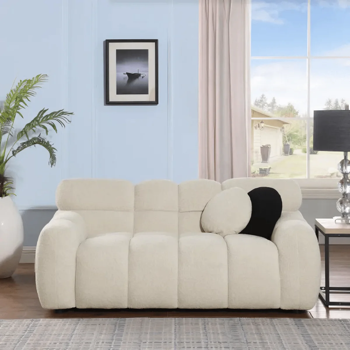 Beige sofa in a living room with a window and plant in the background